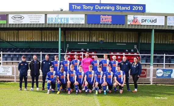 Pickering Town first-team squad and staff lined up in front of the Tony Dunning Stand at Mill Lane