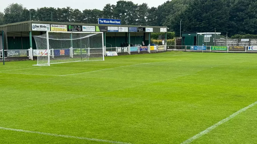 The goal at Mill Lane in front of the Wizzie Wood Stand, with its name board above the sponsor boards